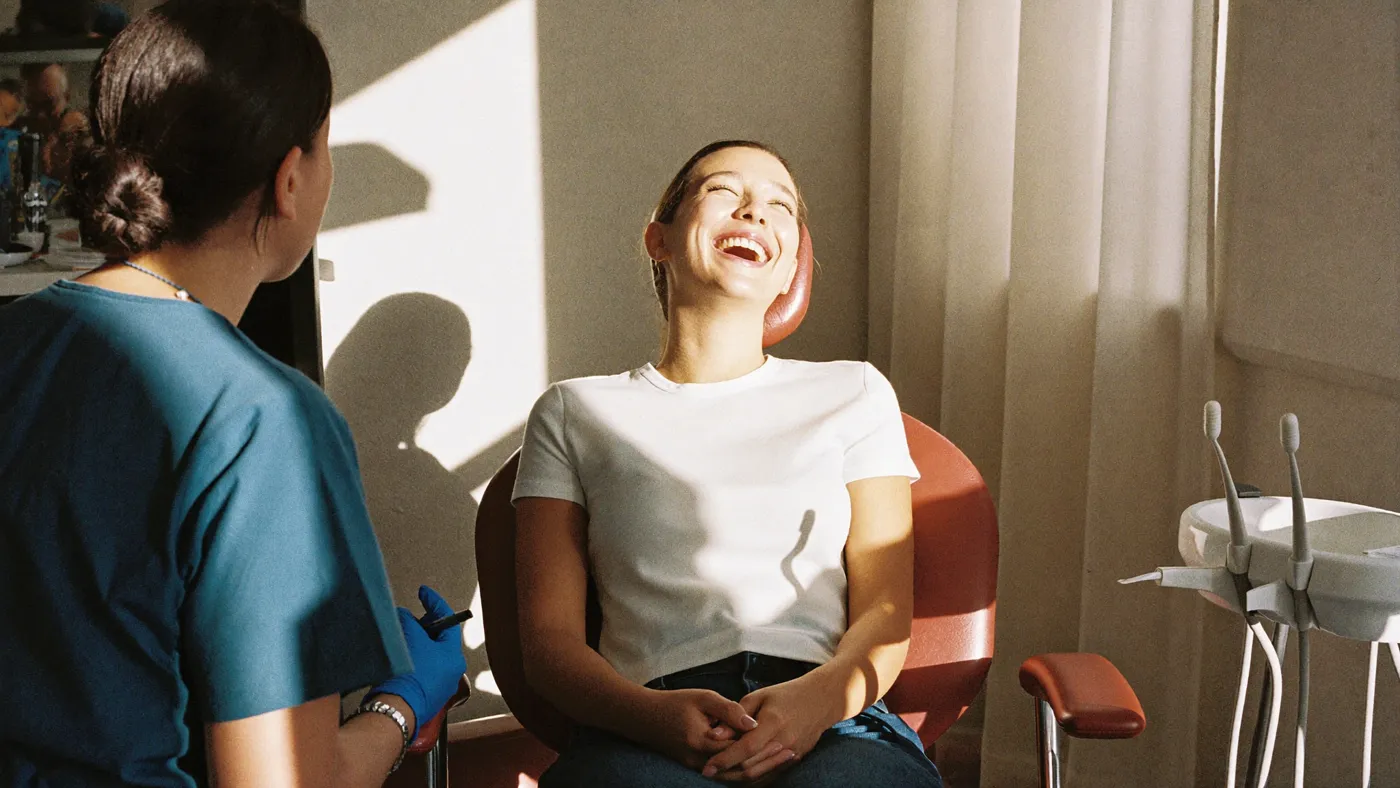 A patient smiling during a visit at a Ora dental studio