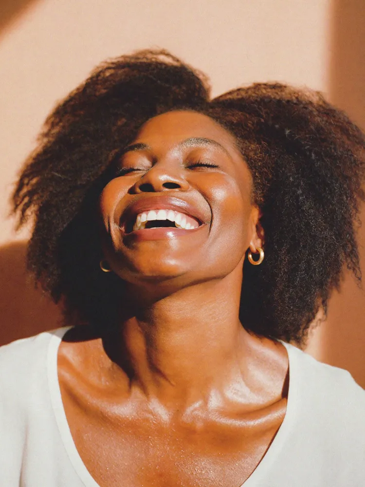 Smiling woman to showcase Philips Zoom teeth whitening at Ora dental